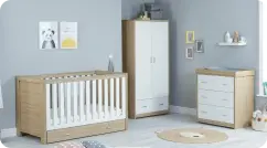 A bright baby's room showcasing a crib and dresser, creating a safe and inviting space for infants.